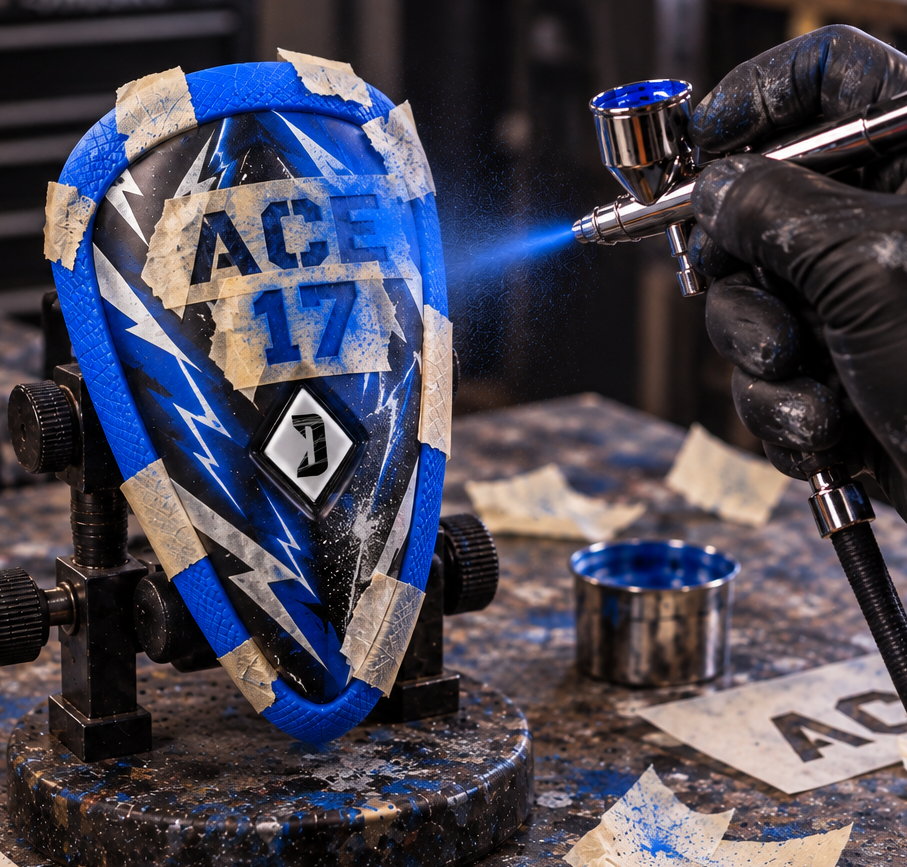 Artist airbrushing a custom design onto a Diamond MMA athletic cup
